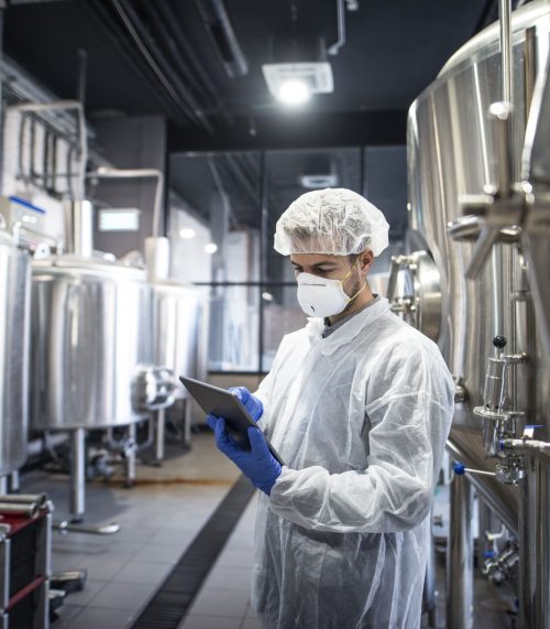 technologist-white-protective-clothes-checking-production-his-tablet (2)